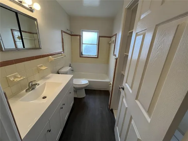 a bathroom with a sink toilet and mirror