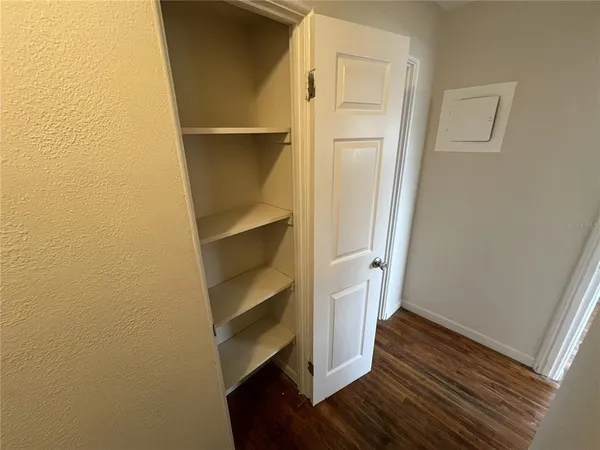 a view of walk in closet with wooden floor