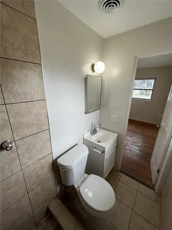 a bathroom with a toilet sink and mirror