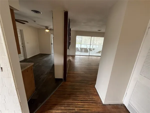 a view of hallway with wooden floor