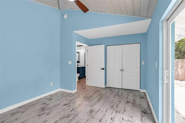a view of a hallway with wooden floor and entryway