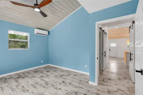 a view of a big room with wooden floor and windows