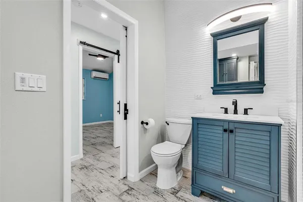 a bathroom with a toilet sink and mirror