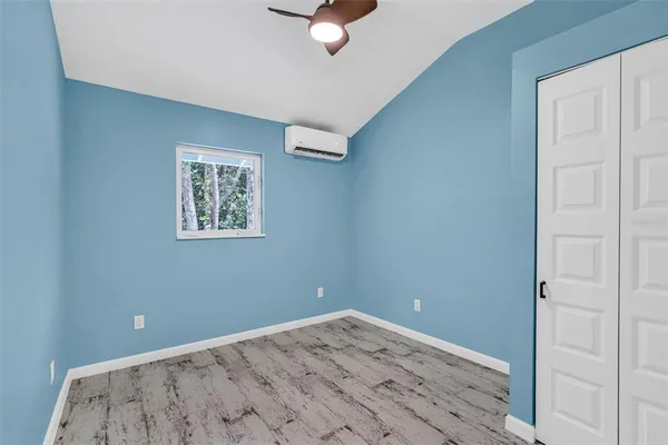 a view of a room with wooden floor and carpet