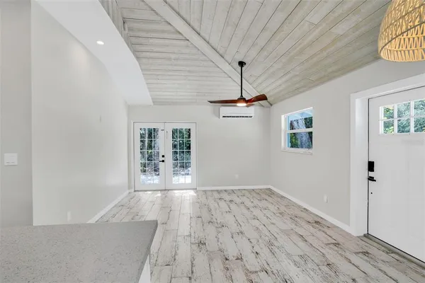 wooden floor in an empty room with a window