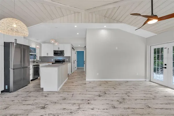 a kitchen with refrigerator and cabinets