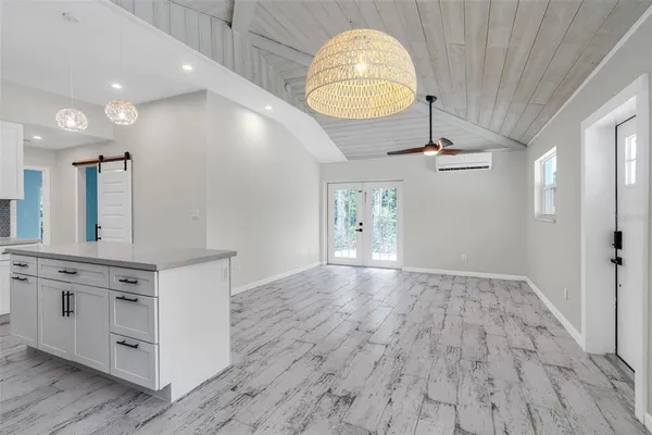 an empty room with wooden floor and mirror