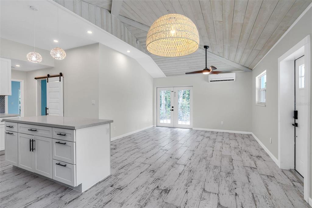 218 Lignumvitae Drive Key Largo, FL 33037 - Photo 4 of 35 an empty room with wooden floor and mirror