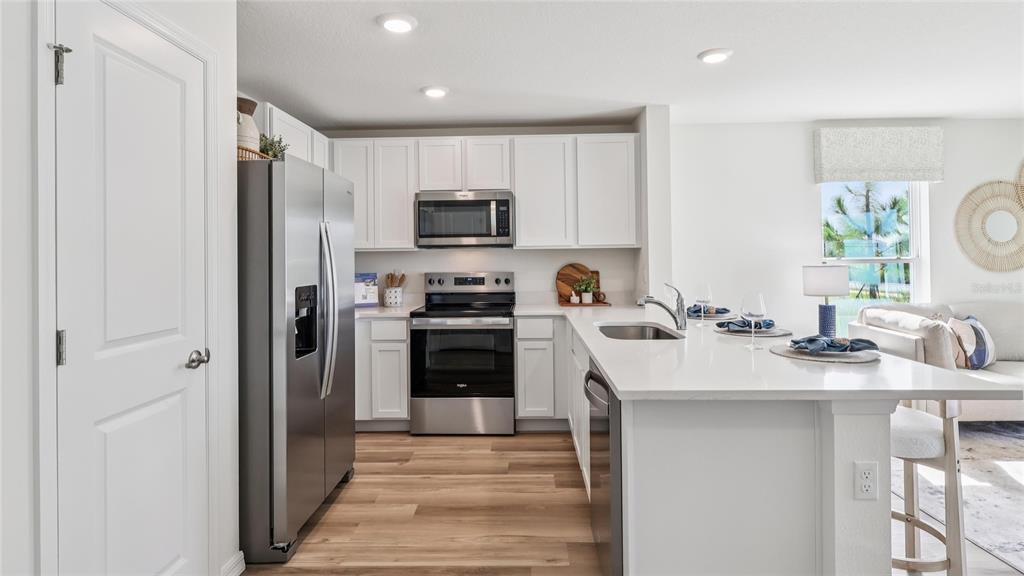 6530 Southwest 82nd Loop Ocala, FL 34476 - Photo 4 of 22 a kitchen with a sink a stove a refrigerator and a sink
