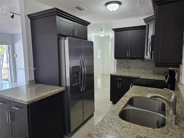 a kitchen with a sink stove and microwave