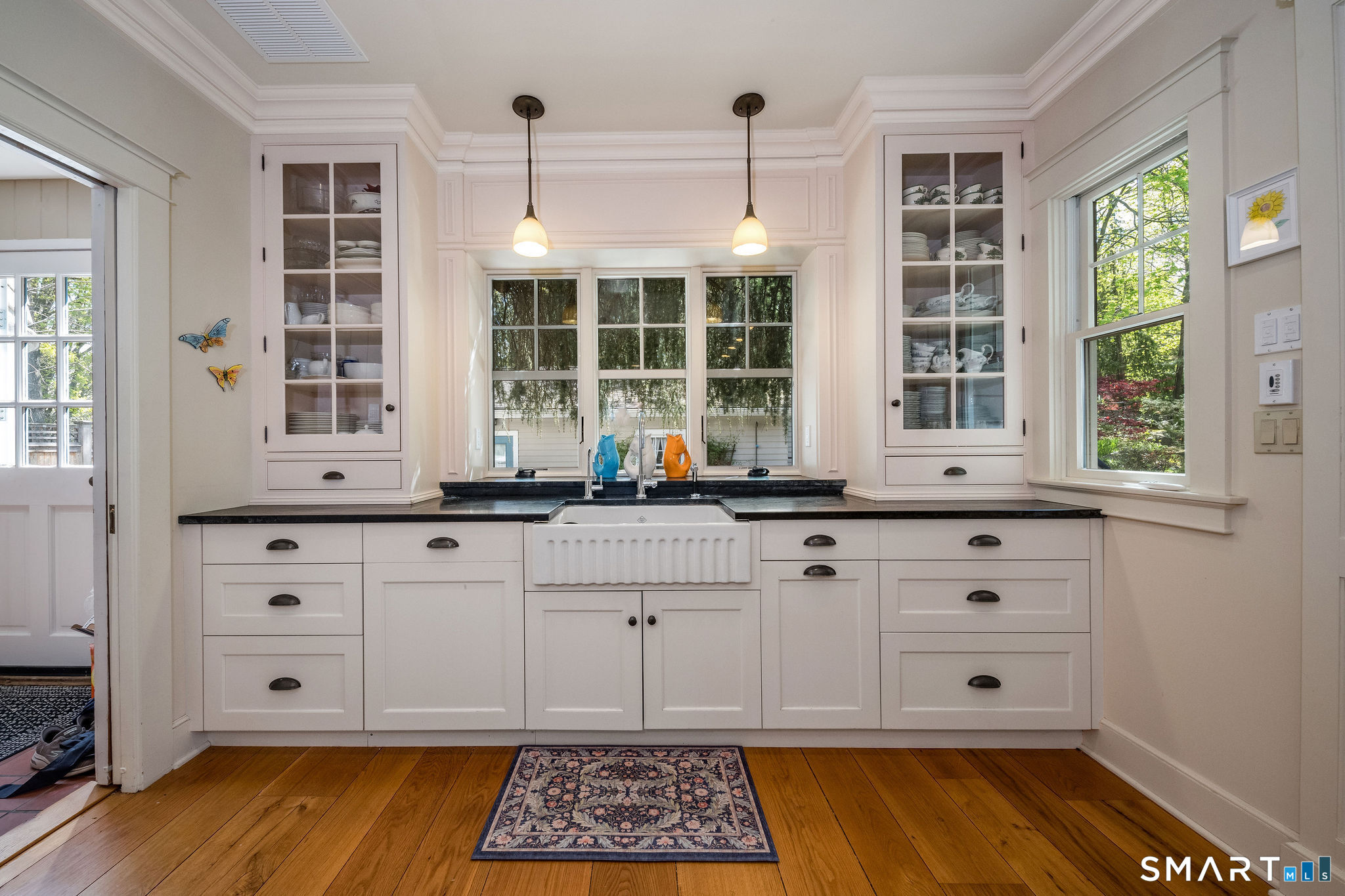 880 Boston Post Road Madison, CT 06443 - Photo 21 of 40 a kitchen with stainless steel appliances granite countertop a stove a sink and white cabinets with wooden floor