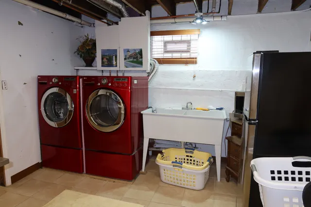 a utility room with dryer washer and a view of living room