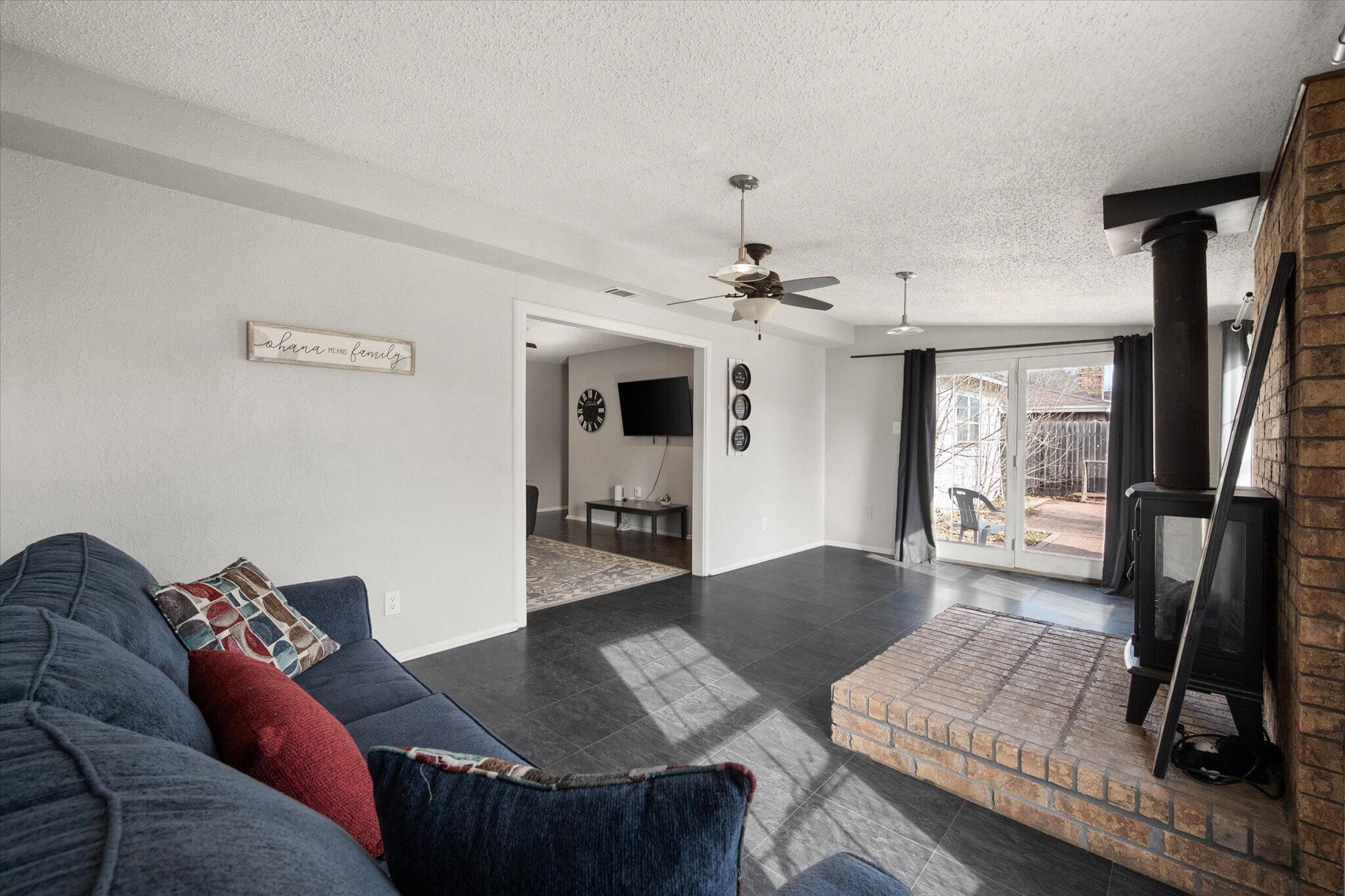 4803 8th Street Lubbock, TX 79416 - Photo 18 of 29 a living room with furniture and a flat screen tv