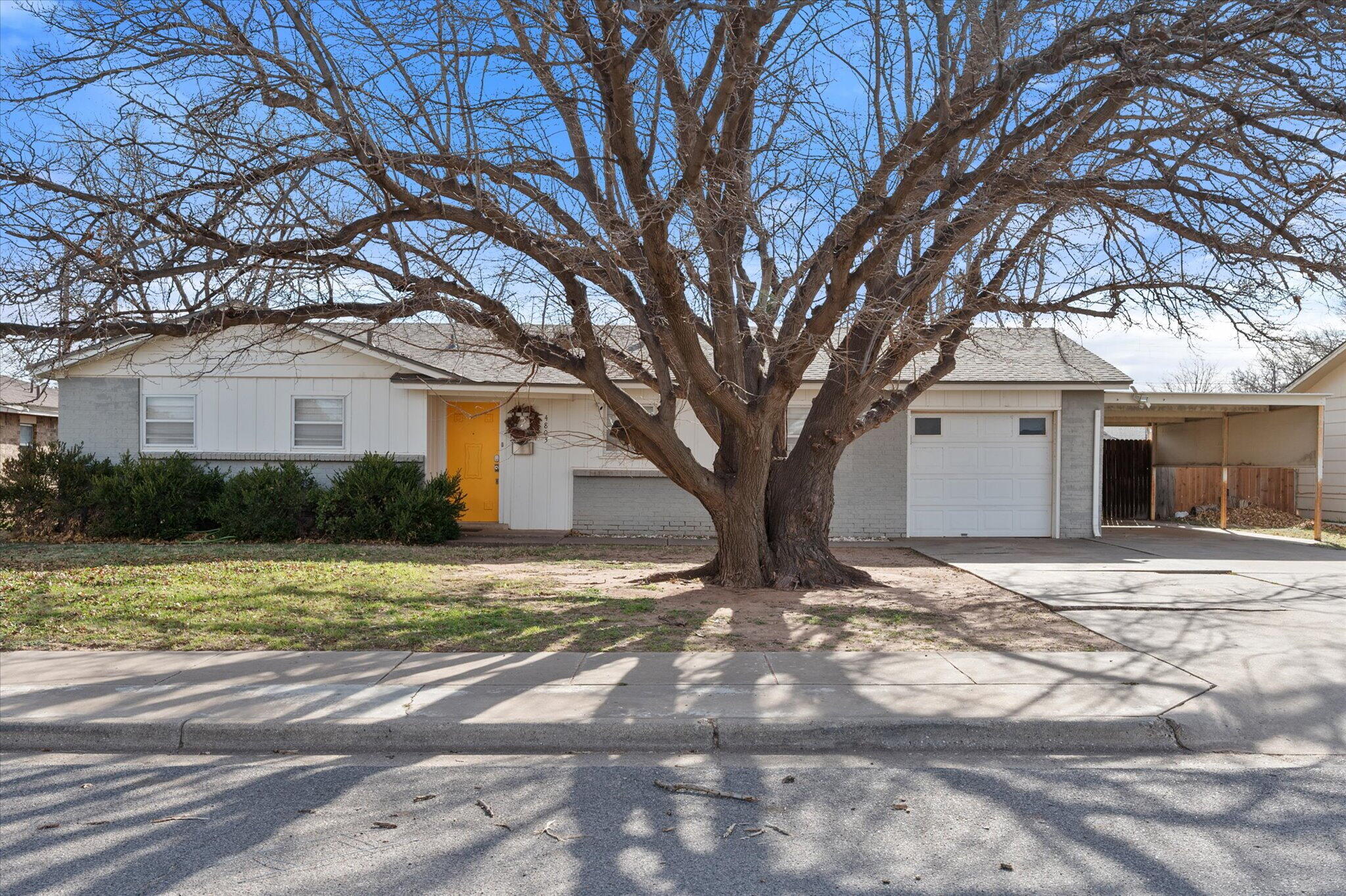 4803 8th Street Lubbock, TX 79416 - Photo 2 of 29 a front view of a house with a yard and garage