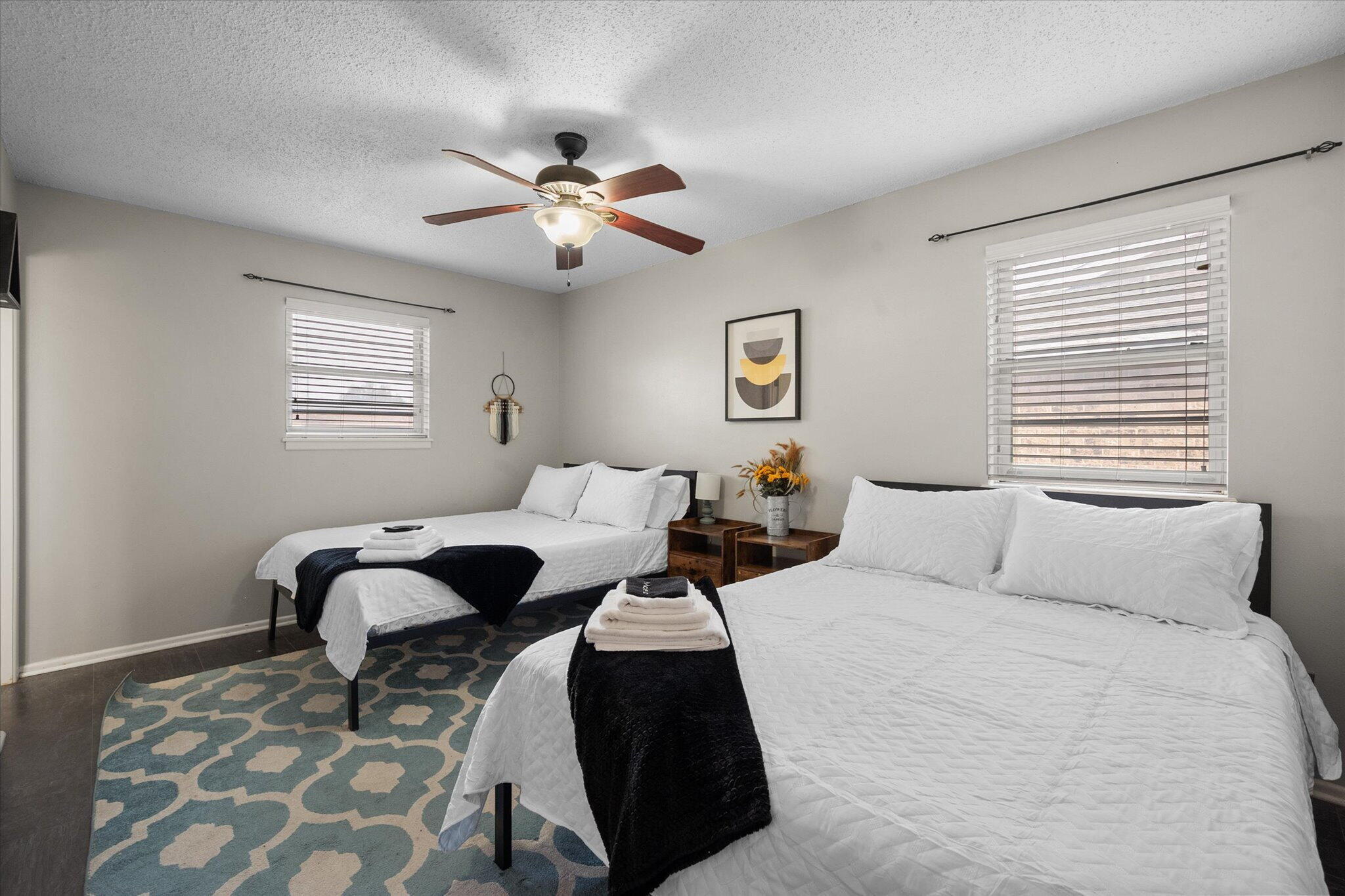 4803 8th Street Lubbock, TX 79416 - Photo 23 of 29 a bedroom with a bed a lamp and a window