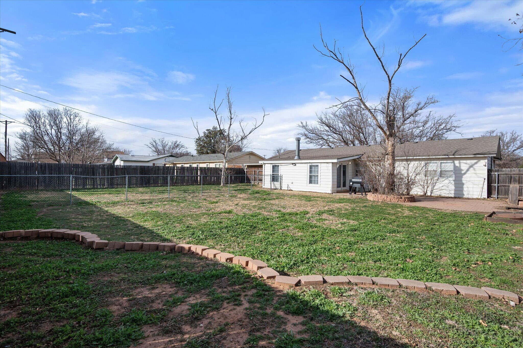 4803 8th Street Lubbock, TX 79416 - Photo 27 of 29 a front view of a house with garden