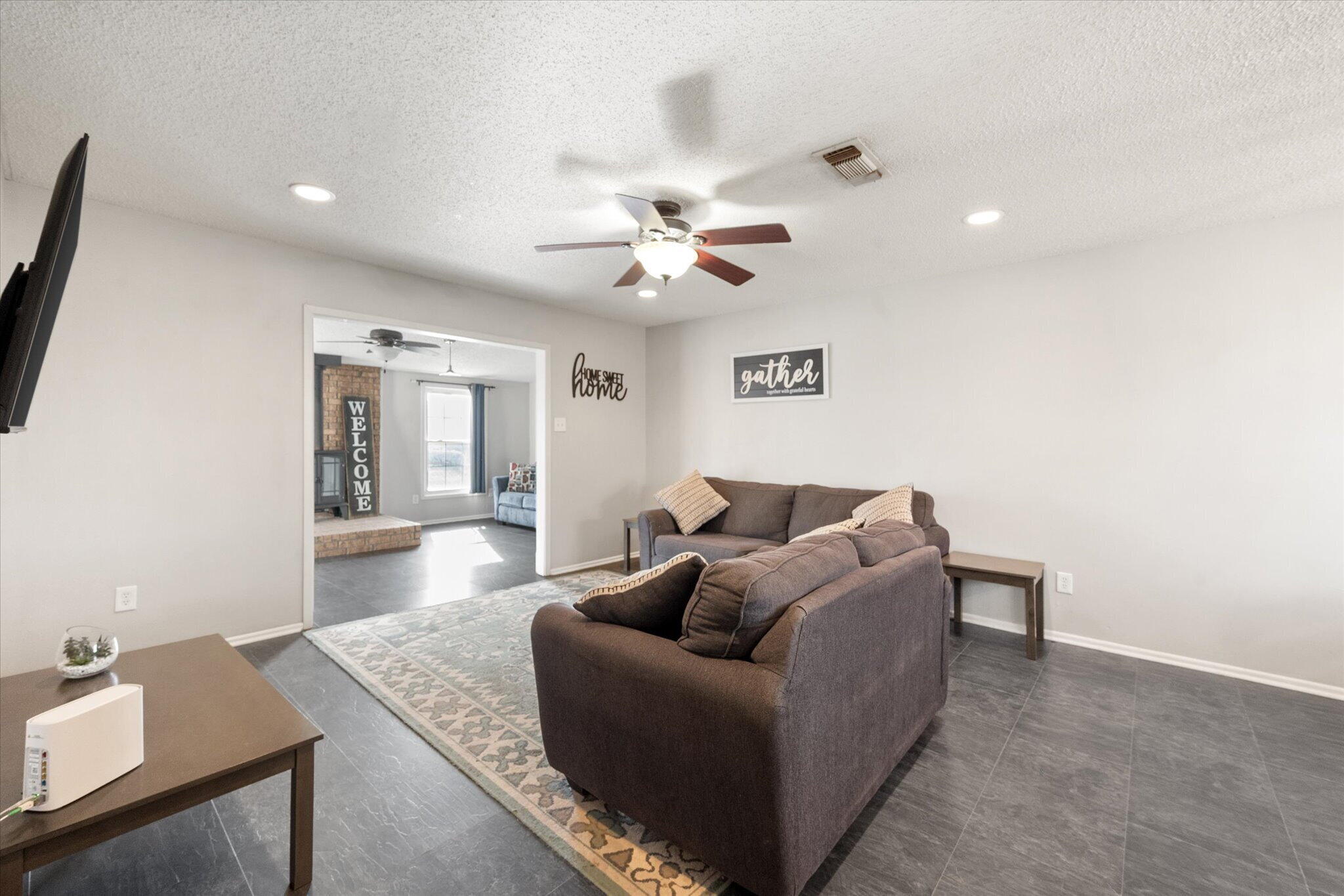 4803 8th Street Lubbock, TX 79416 - Photo 7 of 29 a living room with furniture and a chandelier