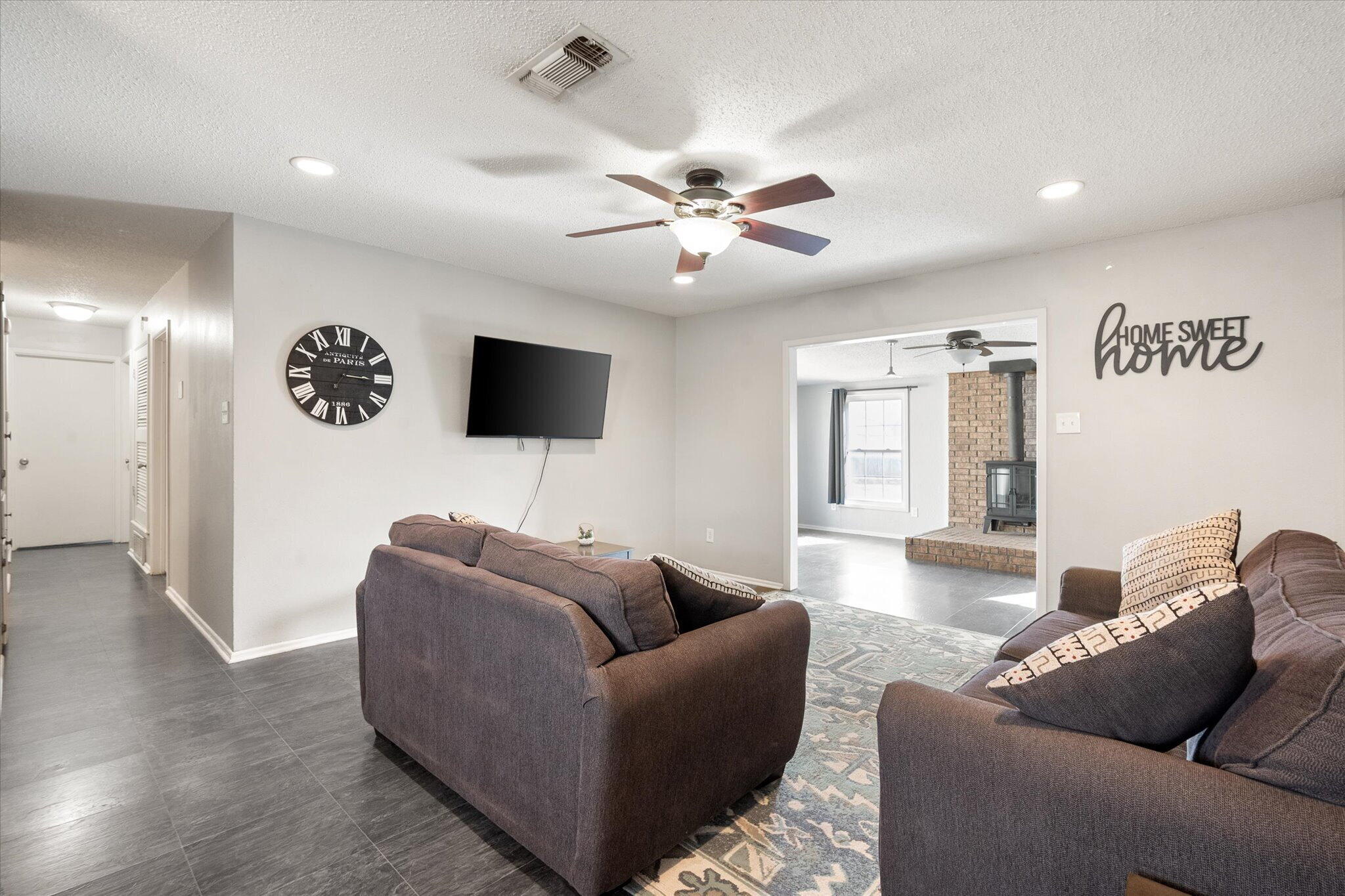 4803 8th Street Lubbock, TX 79416 - Photo 8 of 29 a living room with furniture and a flat screen tv