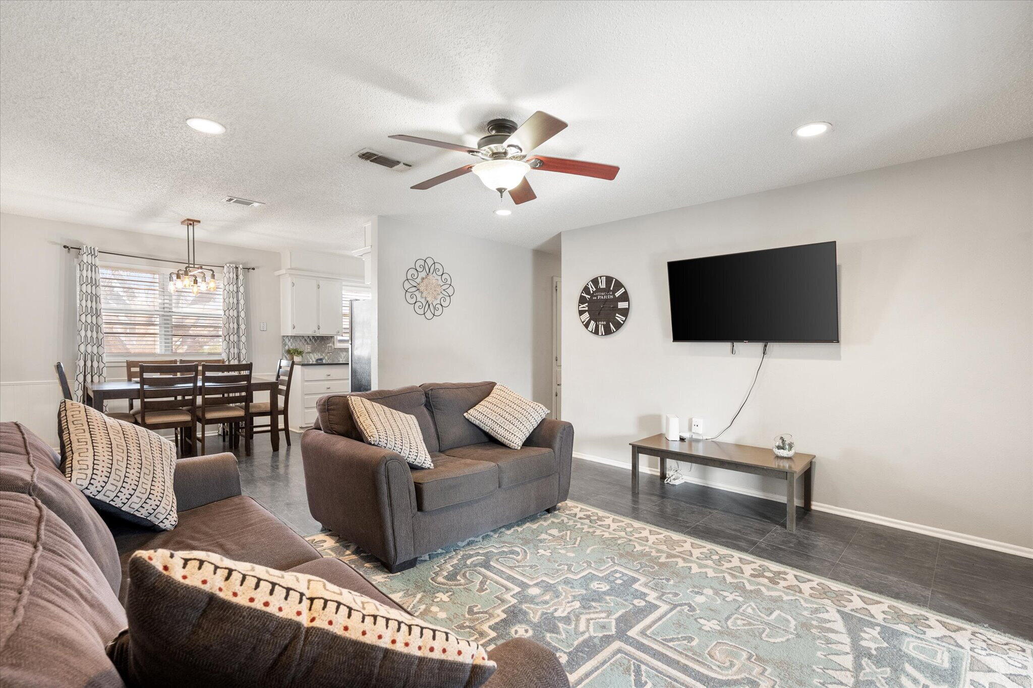 4803 8th Street Lubbock, TX 79416 - Photo 9 of 29 a living room with furniture and a flat screen tv