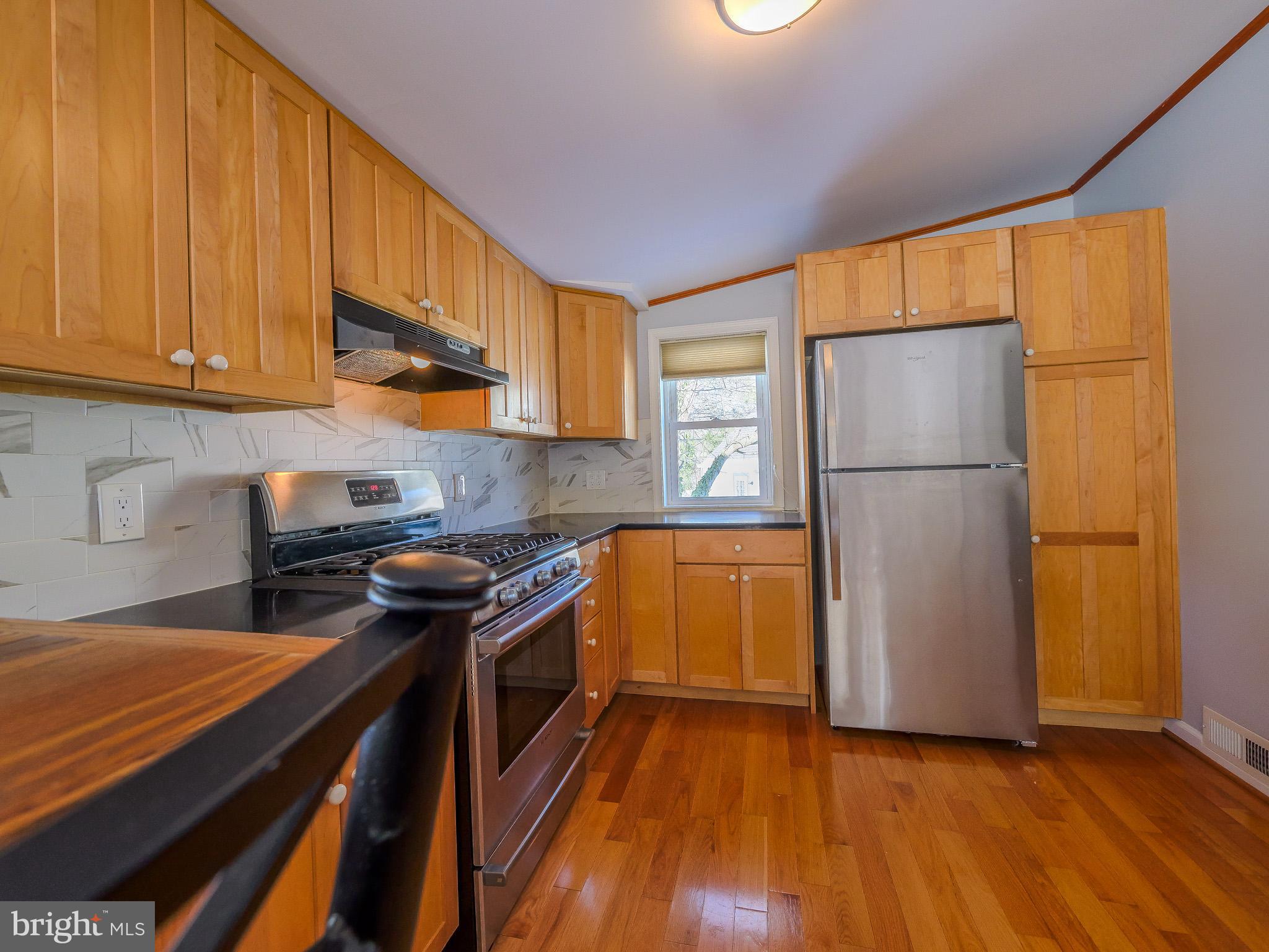 118 North Line Road Newtown Square, PA 19073 - Photo 25 of 69 a kitchen with a refrigerator a stove top oven a sink and cabinets