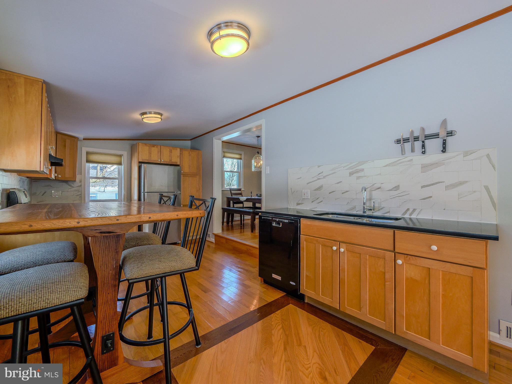 118 North Line Road Newtown Square, PA 19073 - Photo 29 of 69 a kitchen with stainless steel appliances granite countertop a stove a sink dishwasher and white cabinets with wooden floor