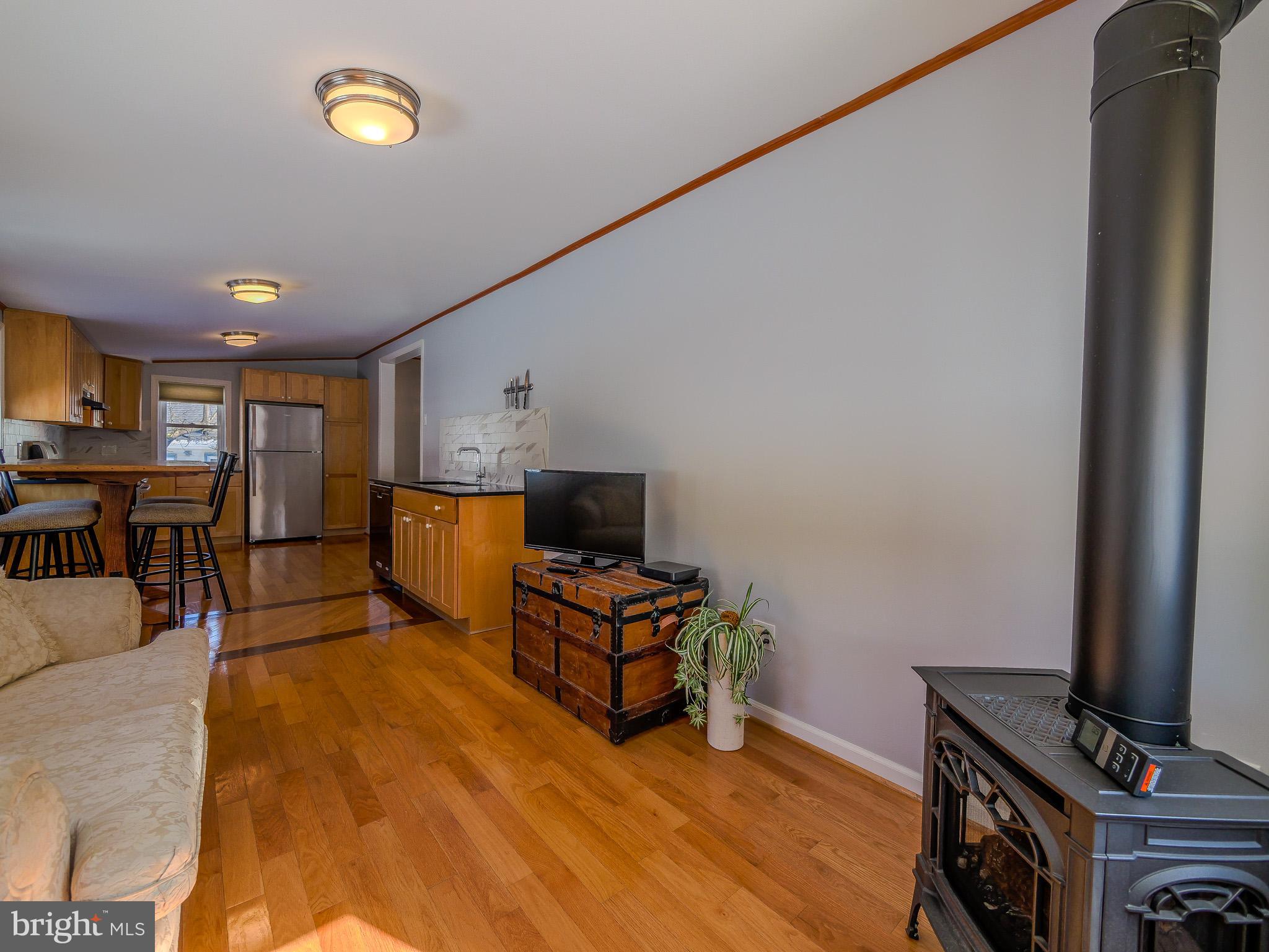 118 North Line Road Newtown Square, PA 19073 - Photo 30 of 69 a living room with furniture and a flat screen tv with kitchen view