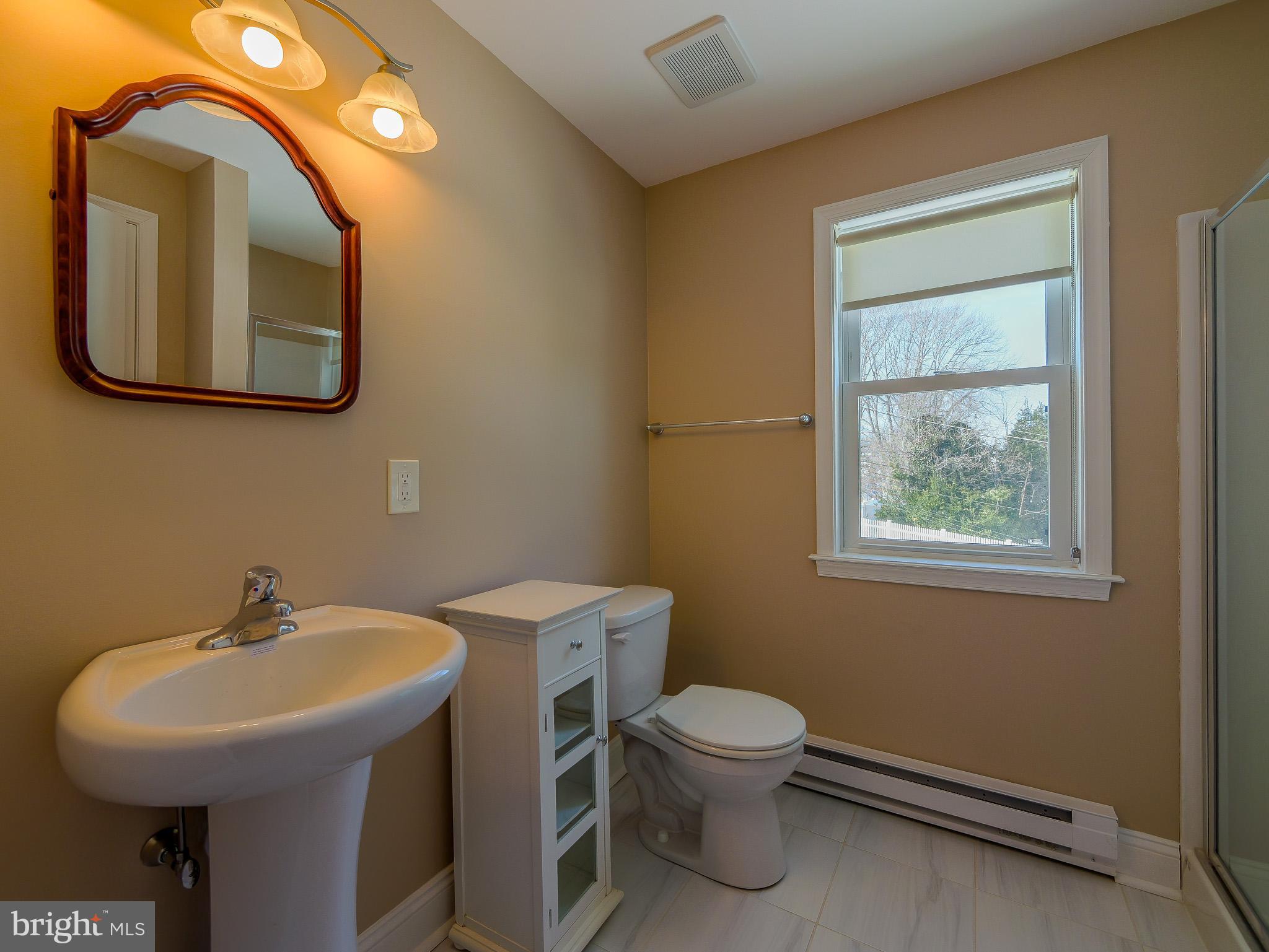 118 North Line Road Newtown Square, PA 19073 - Photo 50 of 69 a bathroom with a toilet sink and mirror