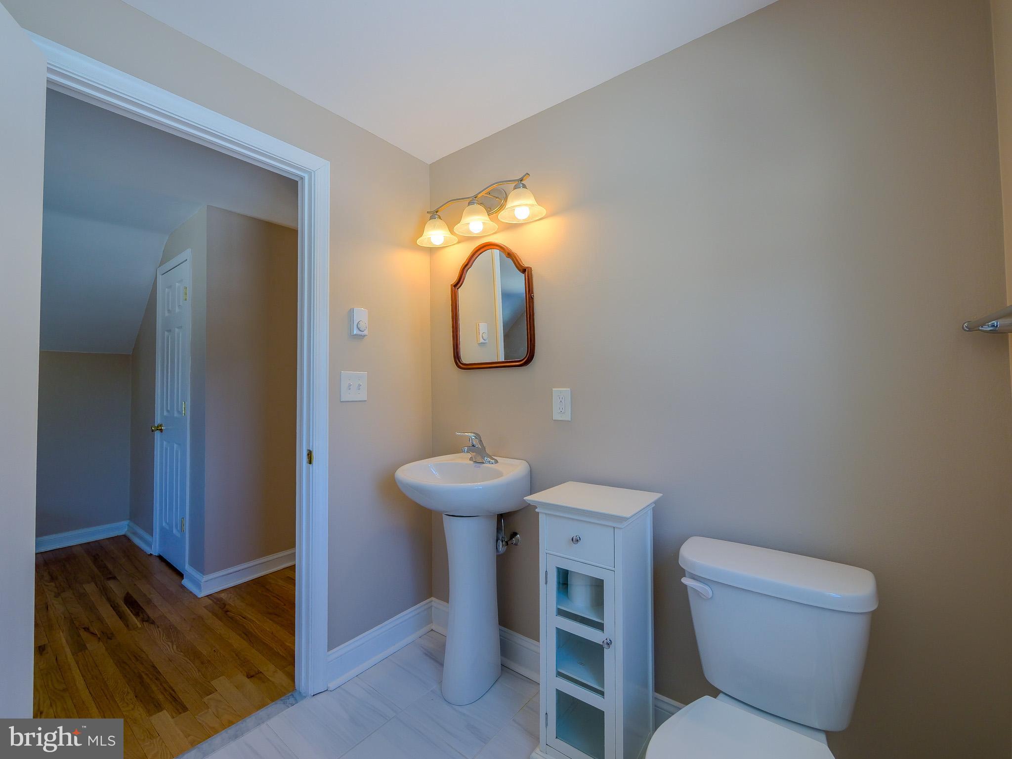 118 North Line Road Newtown Square, PA 19073 - Photo 53 of 69 a bathroom with a toilet sink and mirror