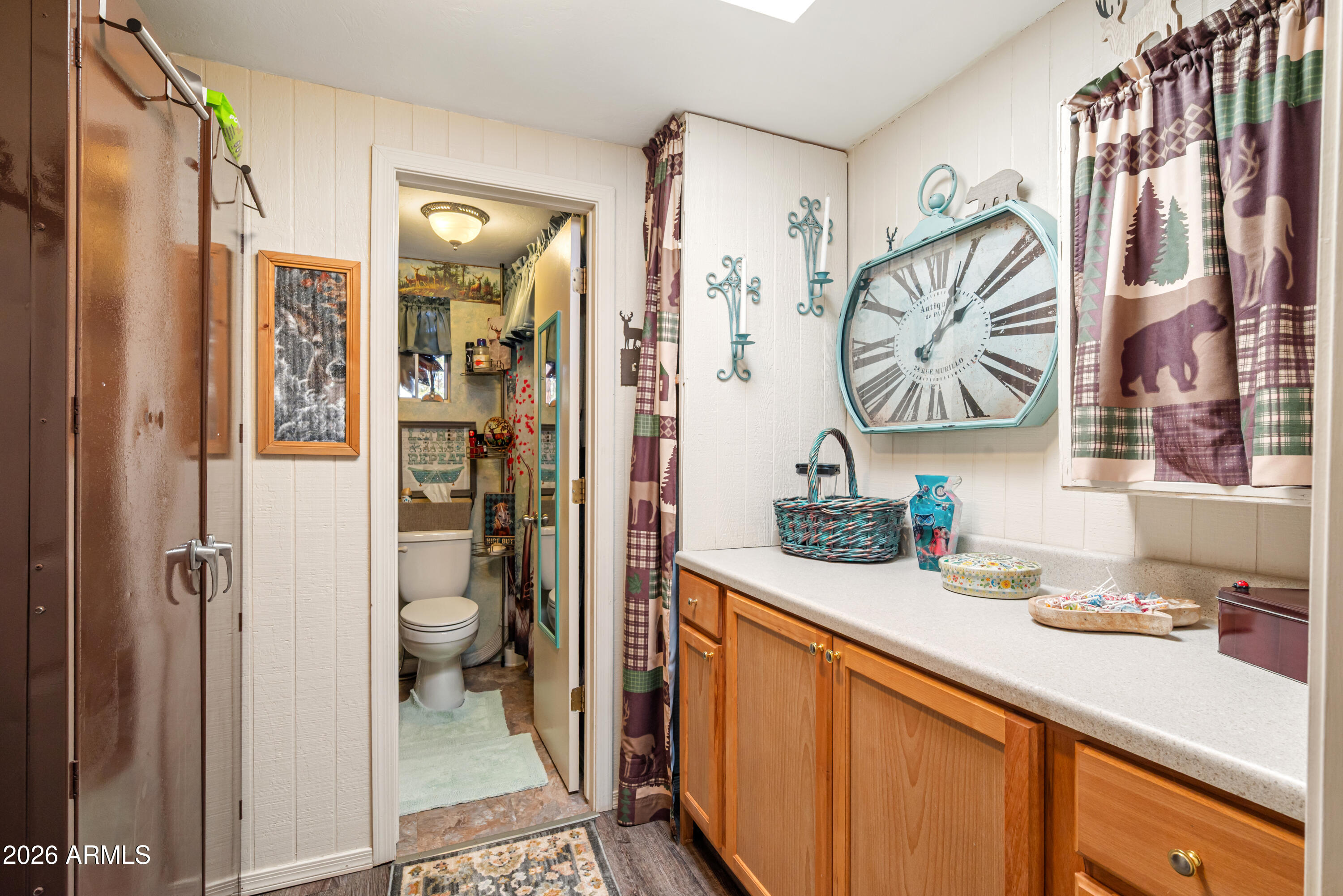 1659 Mormon Road Happy Jack, AZ 86024 - Photo 24 of 37 a bathroom with a sink a toilet and a shower curtain