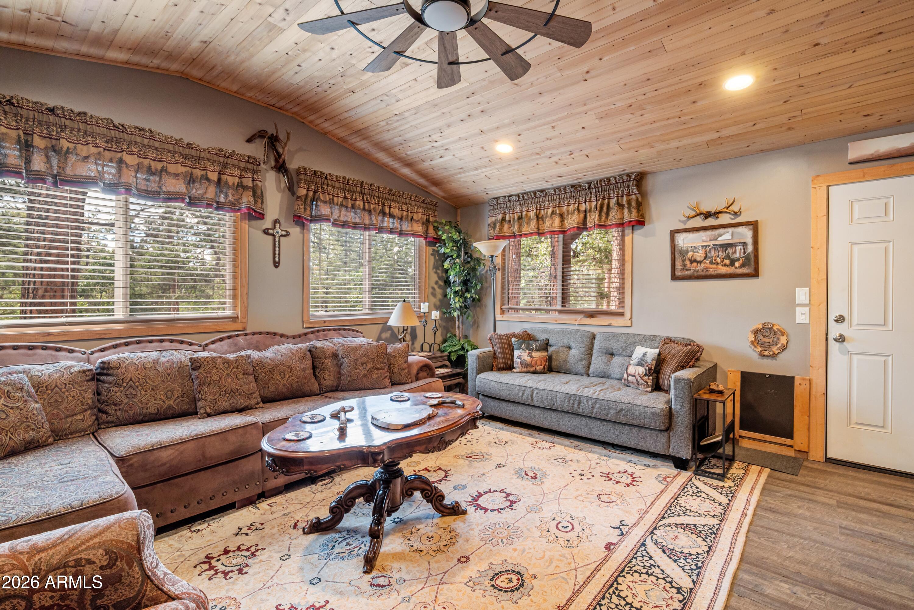 1659 Mormon Road Happy Jack, AZ 86024 - Photo 6 of 37 a living room with furniture and a large window