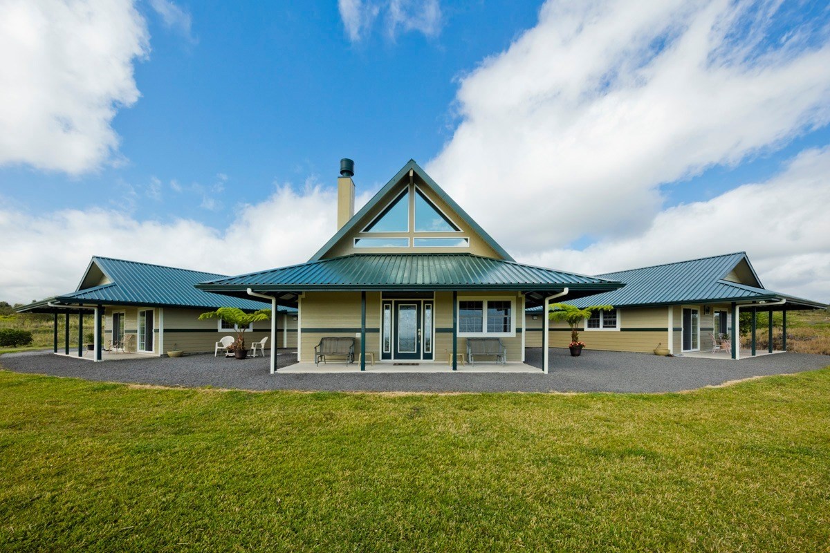 a front view of a house with swimming pool and porch