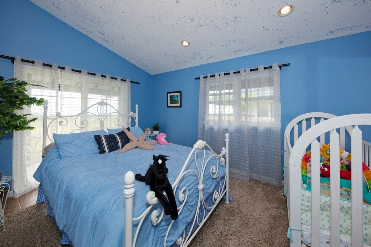 18-4235 North Pszyk Road Mountain View, HI 96771 - Photo 11 of 30 a bedroom with furniture and a window