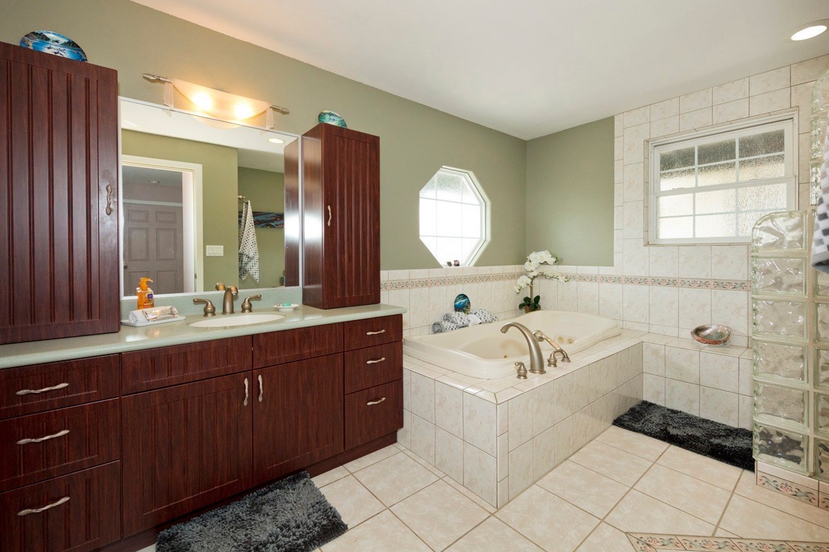 18-4235 North Pszyk Road Mountain View, HI 96771 - Photo 18 of 30 a bathroom with a tub sink and mirror