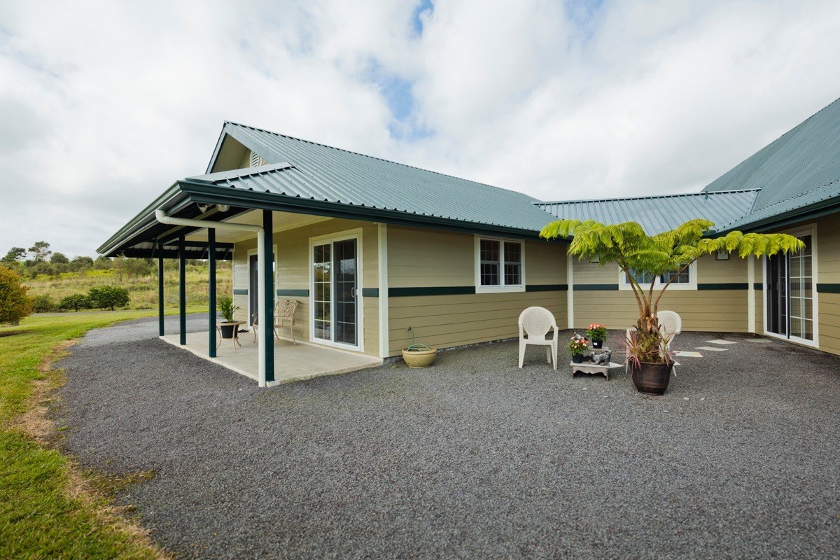 18-4235 North Pszyk Road Mountain View, HI 96771 - Photo 24 of 30 a view of a house with porch and chairs