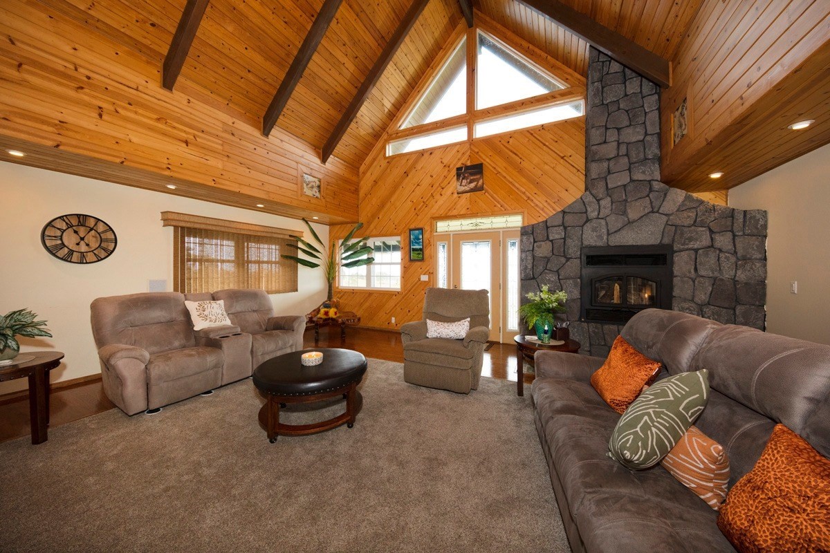 18-4235 North Pszyk Road Mountain View, HI 96771 - Photo 3 of 30 a living room with furniture a fireplace and a large window