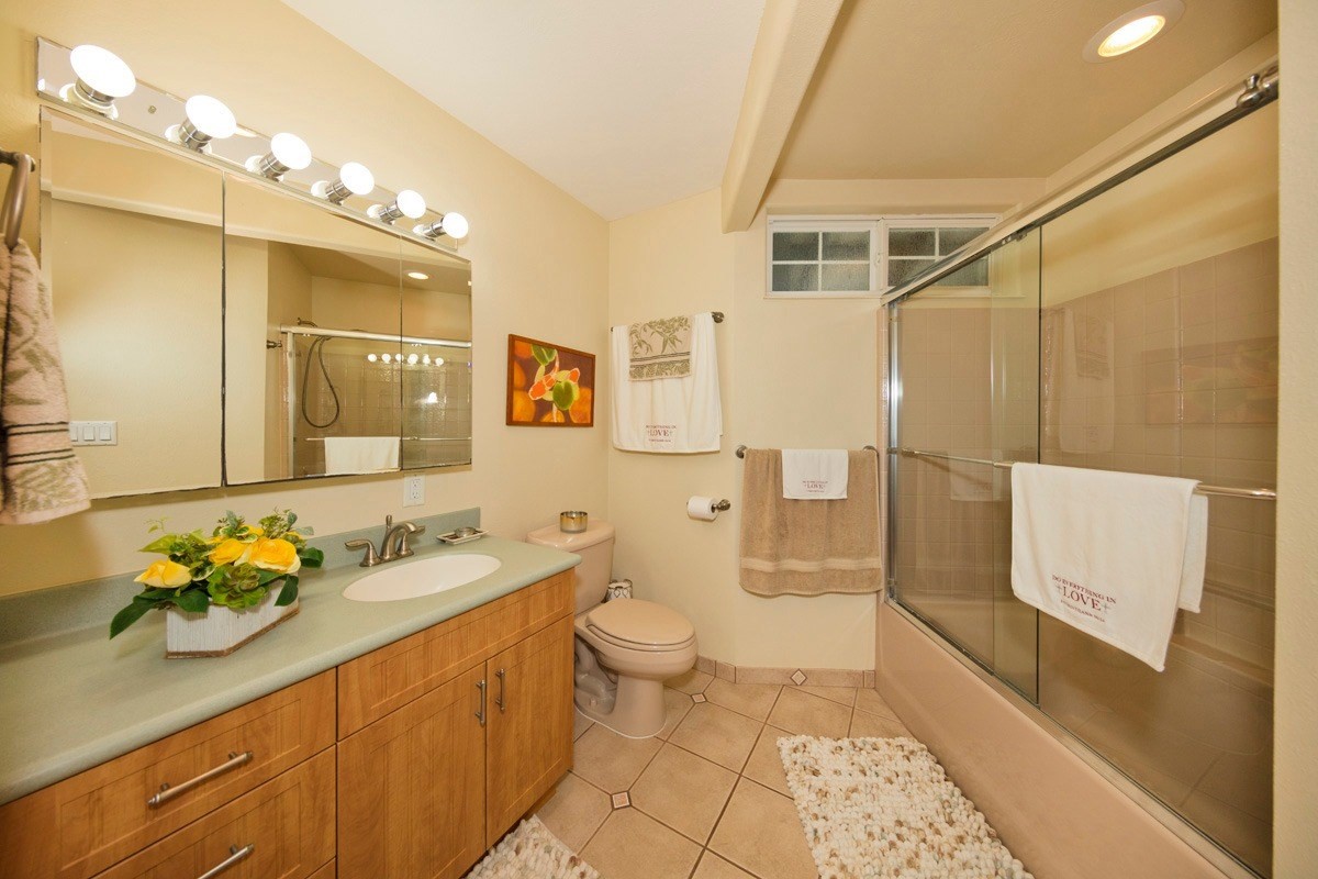 18-4235 North Pszyk Road Mountain View, HI 96771 - Photo 10 of 30 a spacious bathroom with a granite countertop sink a toilet a mirror and shower