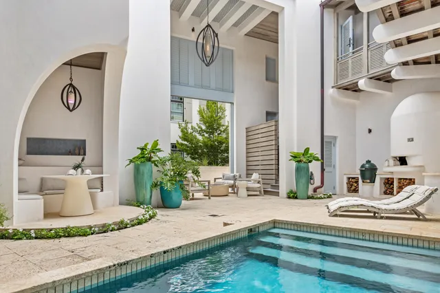 a living room with furniture a fireplace and a potted plant