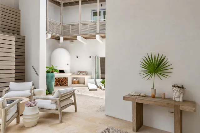 a bedroom with a large bed and a flat tv screen on dresser