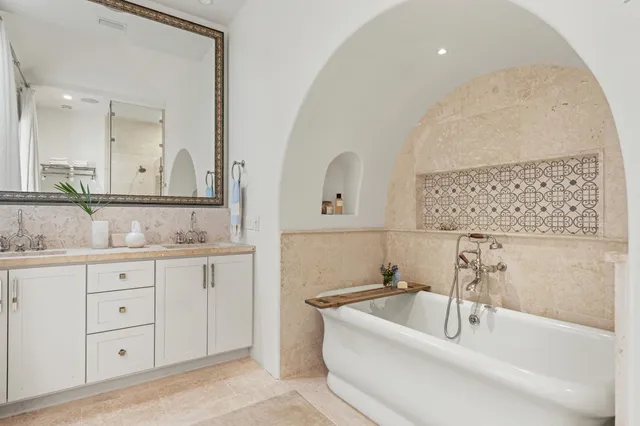 a bathroom with a double vanity sink and a bathtub