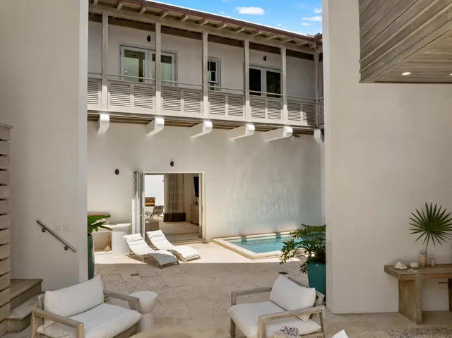 a balcony with furniture and a potted plant