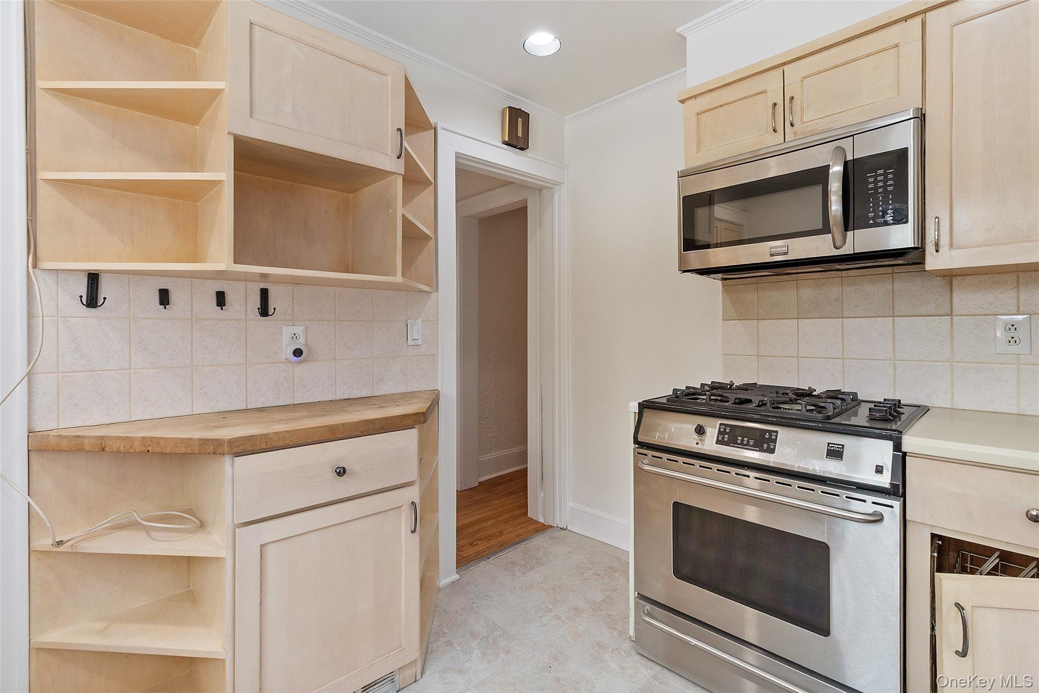 23 Garretson Road White Plains, NY 10604 - Photo 12 of 33 a kitchen with stainless steel appliances granite countertop white cabinets and black stove top oven
