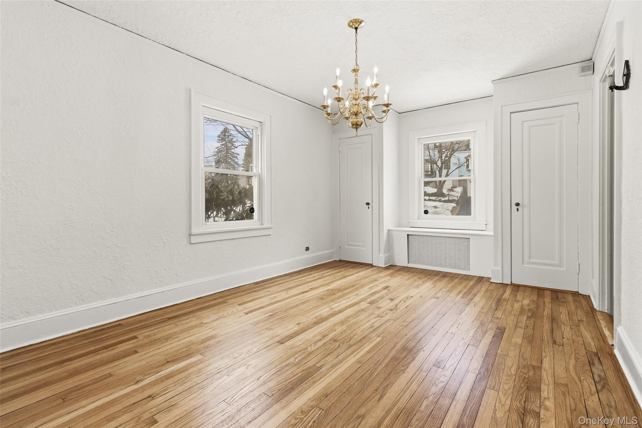 23 Garretson Road White Plains, NY 10604 - Photo 15 of 33 a view of an empty room with a window and wooden floor