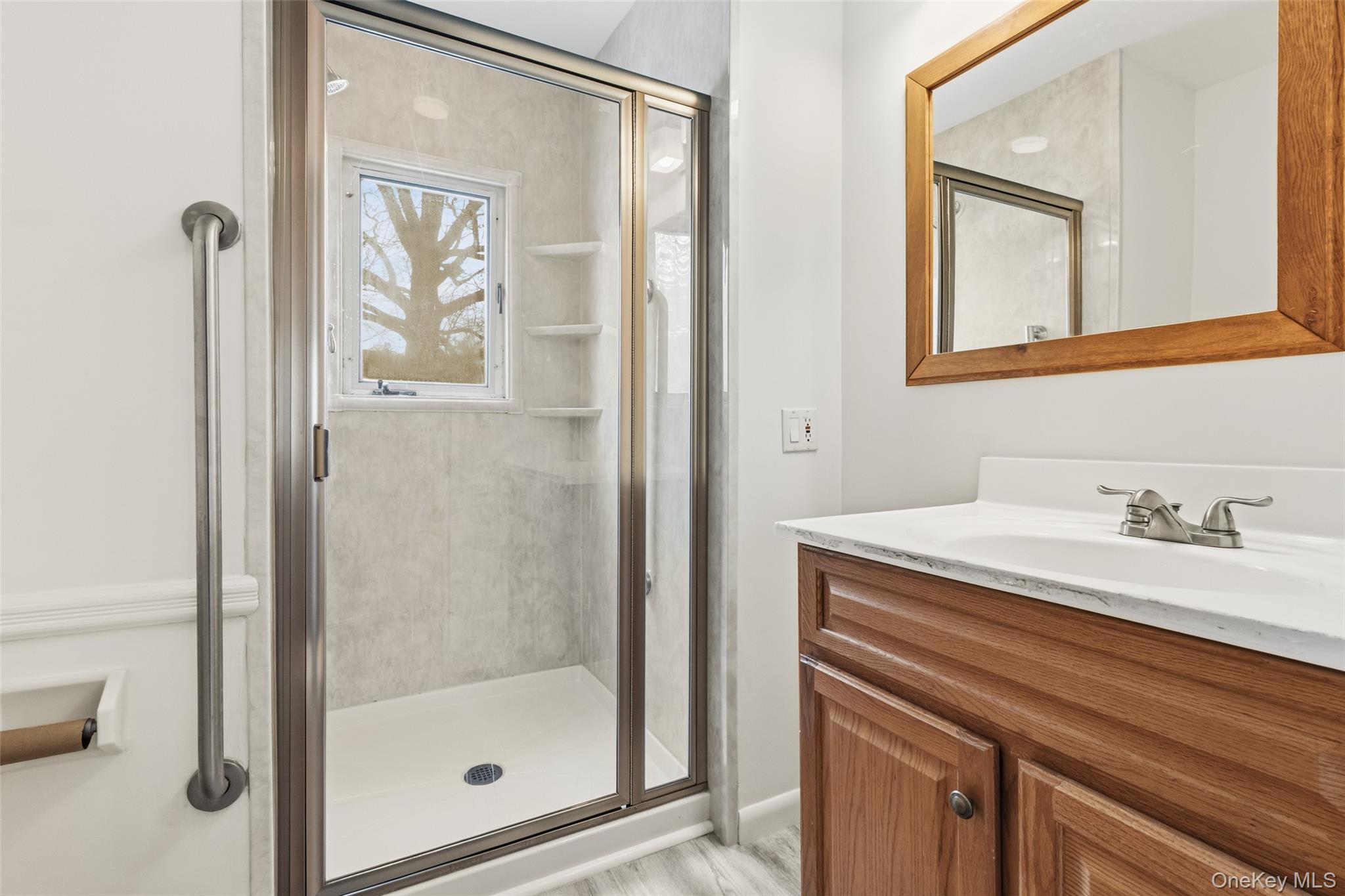 23 Garretson Road White Plains, NY 10604 - Photo 18 of 33 a bathroom with a granite countertop sink a mirror and a shower