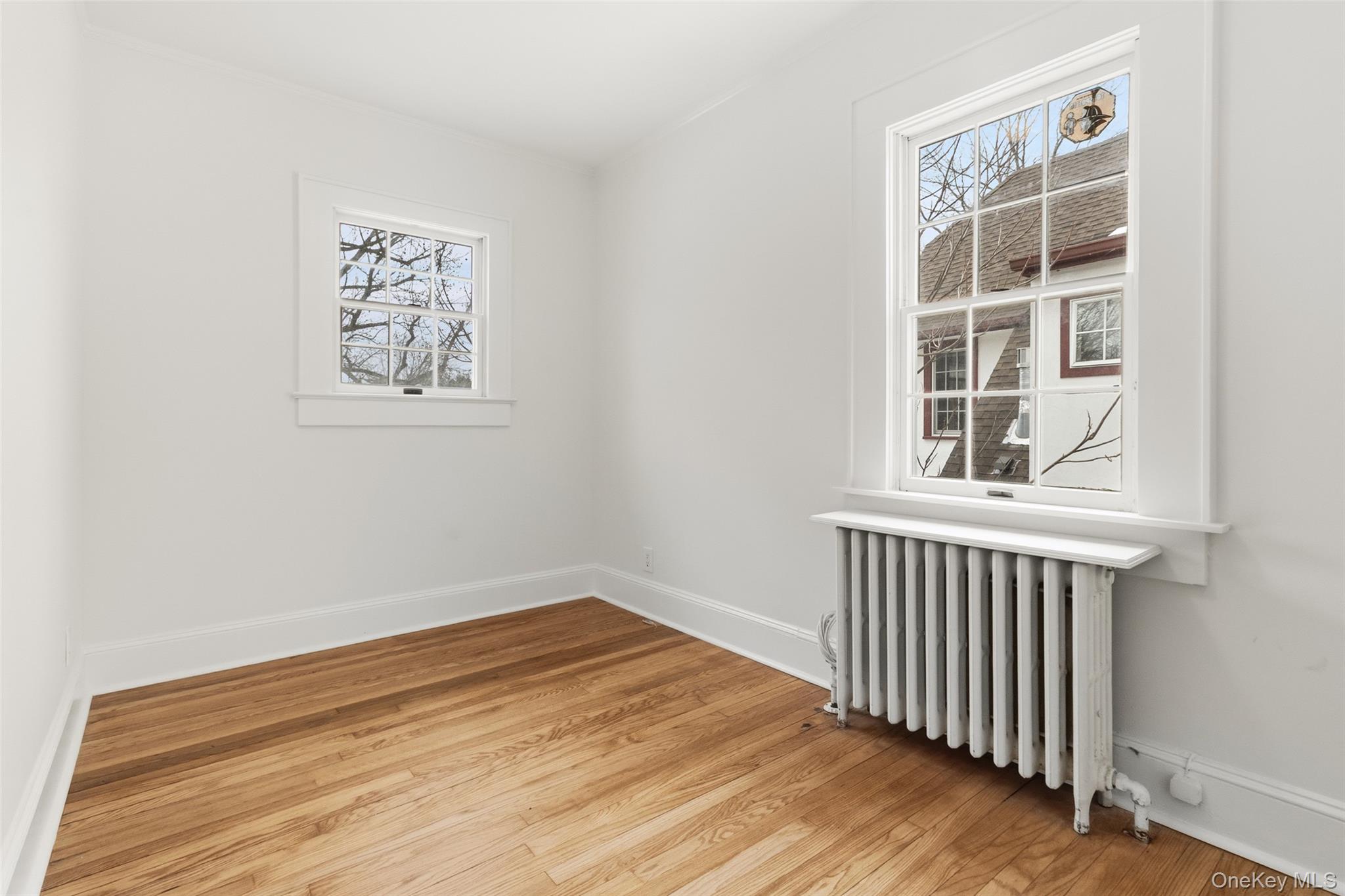23 Garretson Road White Plains, NY 10604 - Photo 22 of 33 an empty room with wooden floor and windows