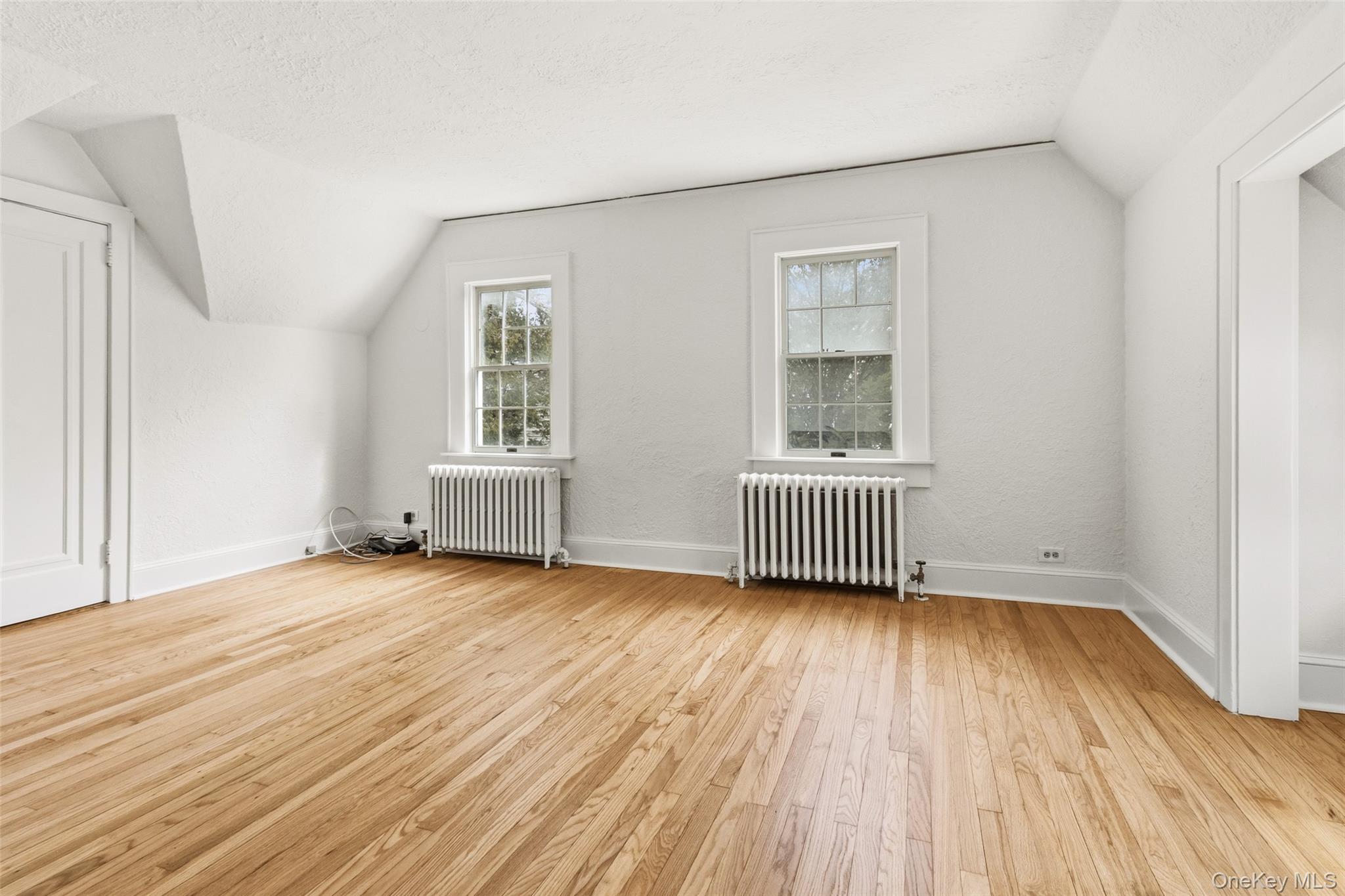23 Garretson Road White Plains, NY 10604 - Photo 25 of 33 an empty room with wooden floor and windows