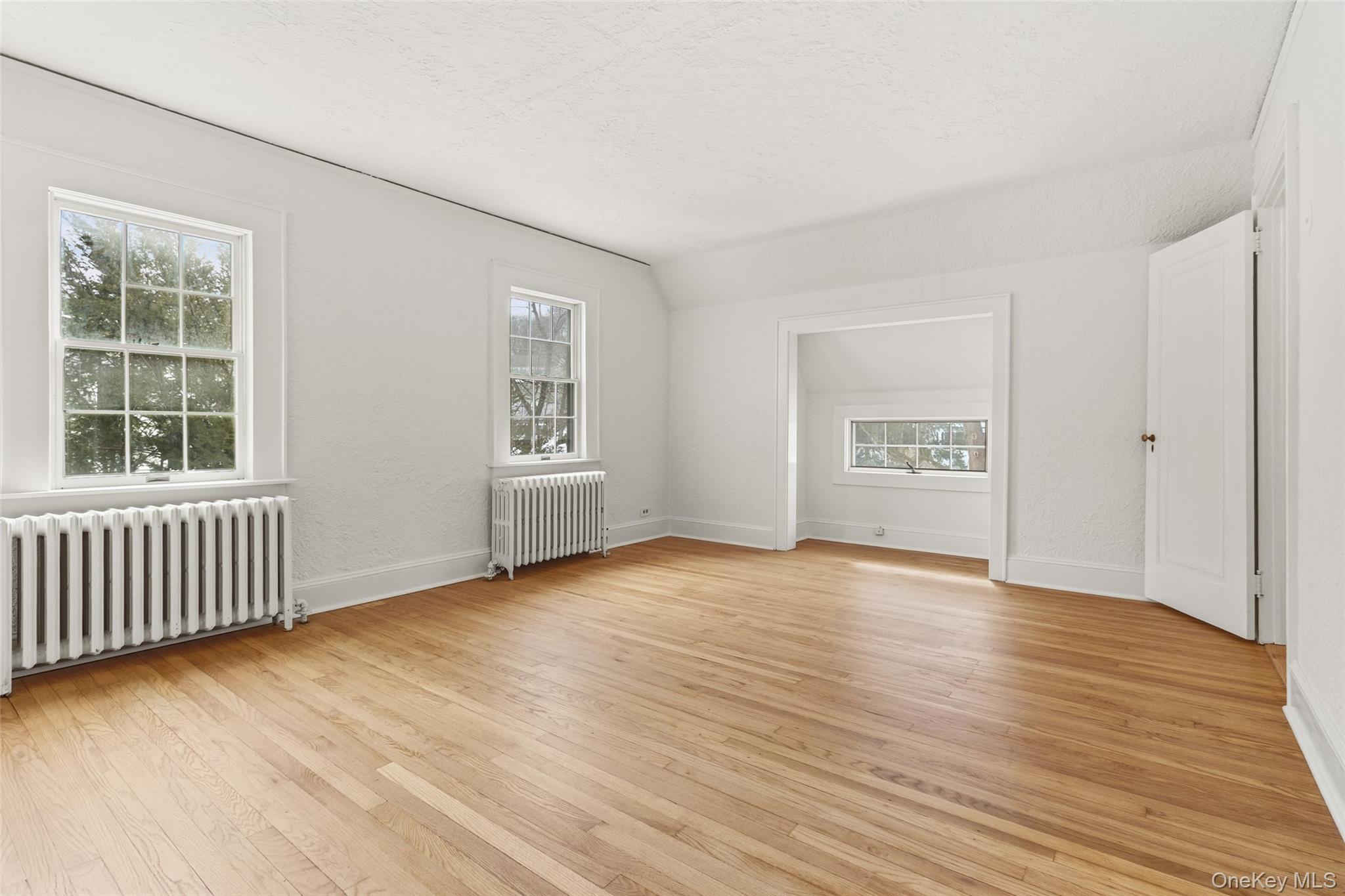 23 Garretson Road White Plains, NY 10604 - Photo 26 of 33 an empty room with wooden floor and windows
