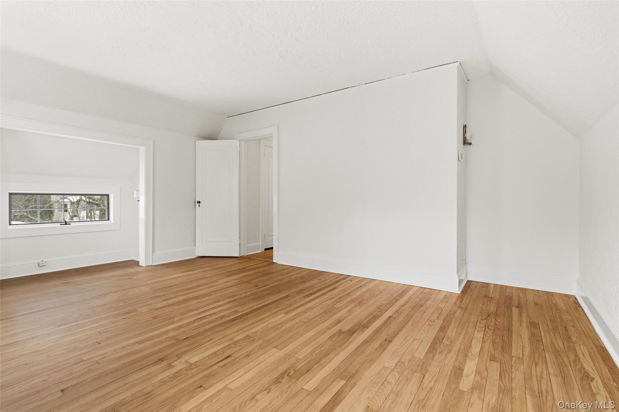 23 Garretson Road White Plains, NY 10604 - Photo 28 of 33 a view of an empty room with wooden floor