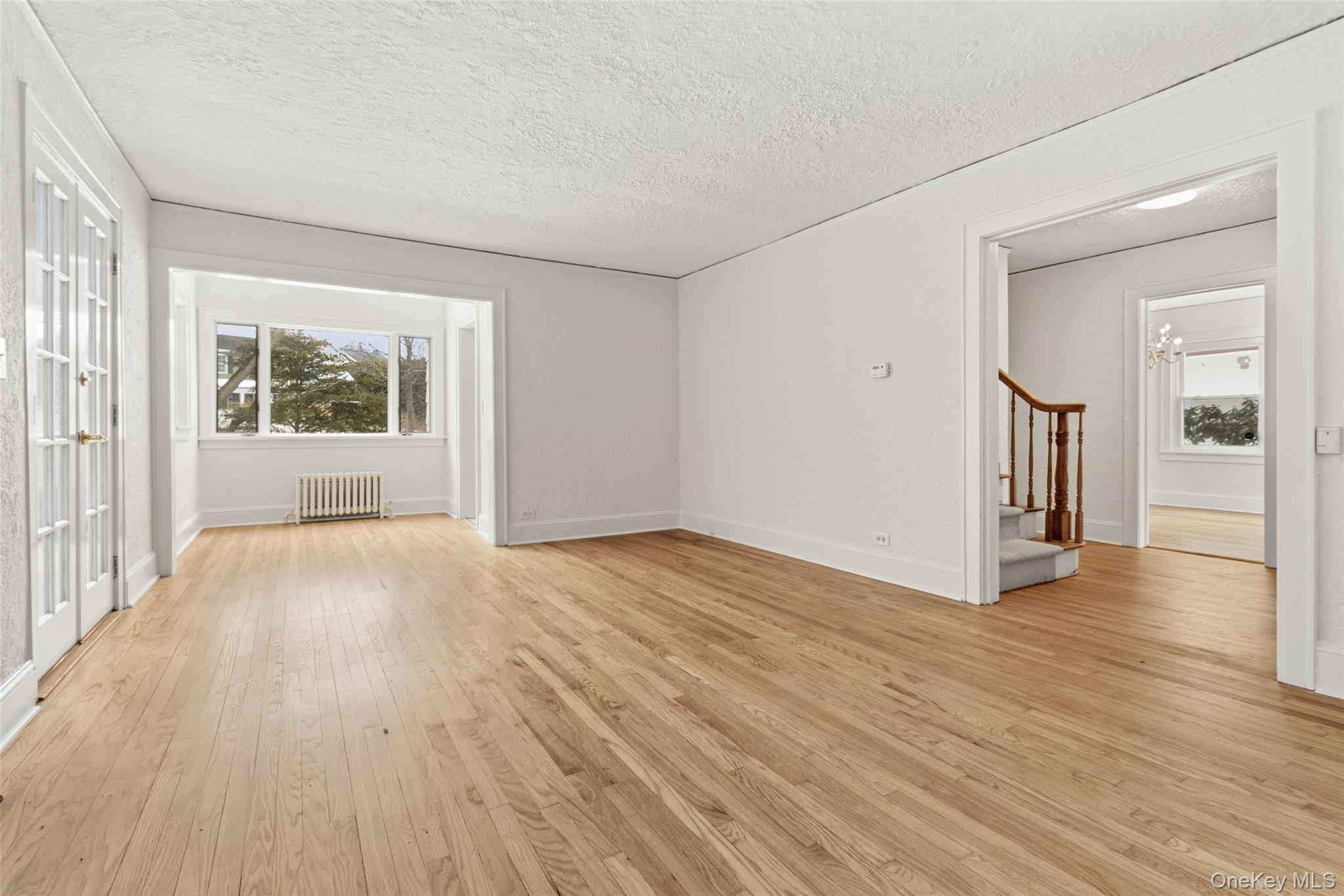 23 Garretson Road White Plains, NY 10604 - Photo 5 of 33 a view of an empty room with wooden floor and a window
