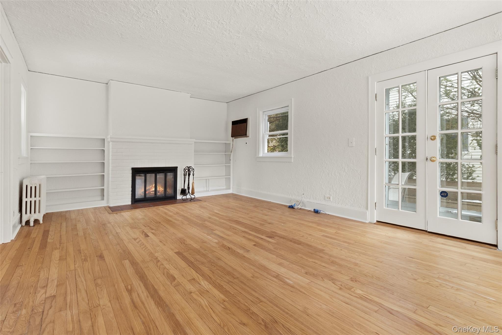 23 Garretson Road White Plains, NY 10604 - Photo 6 of 33 a view of empty room with wooden floor and fireplace