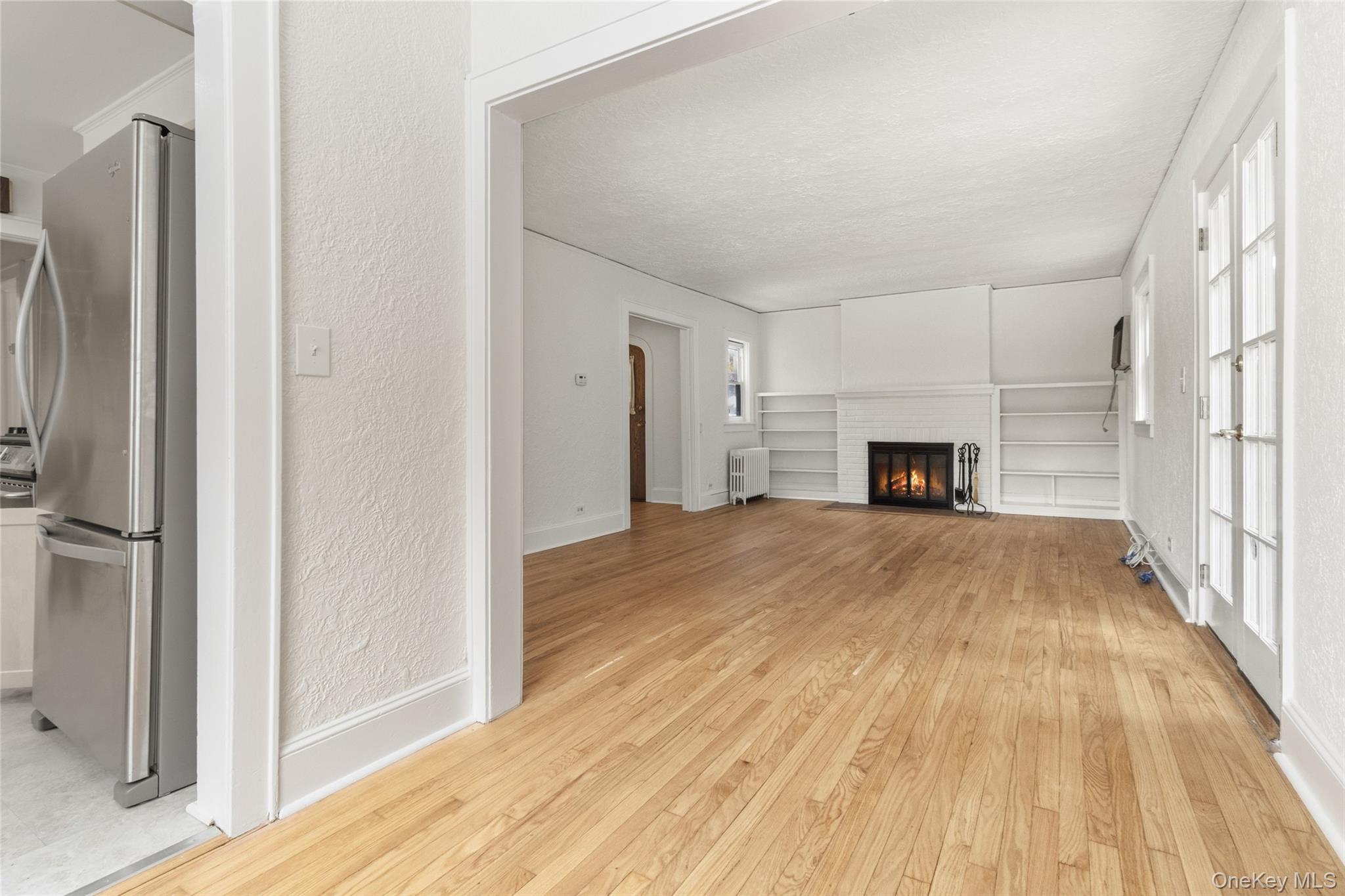 23 Garretson Road White Plains, NY 10604 - Photo 7 of 33 a view of empty room with a fireplace and wooden floor